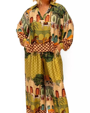 Woman wearing a colorful patterned outfit on a white background