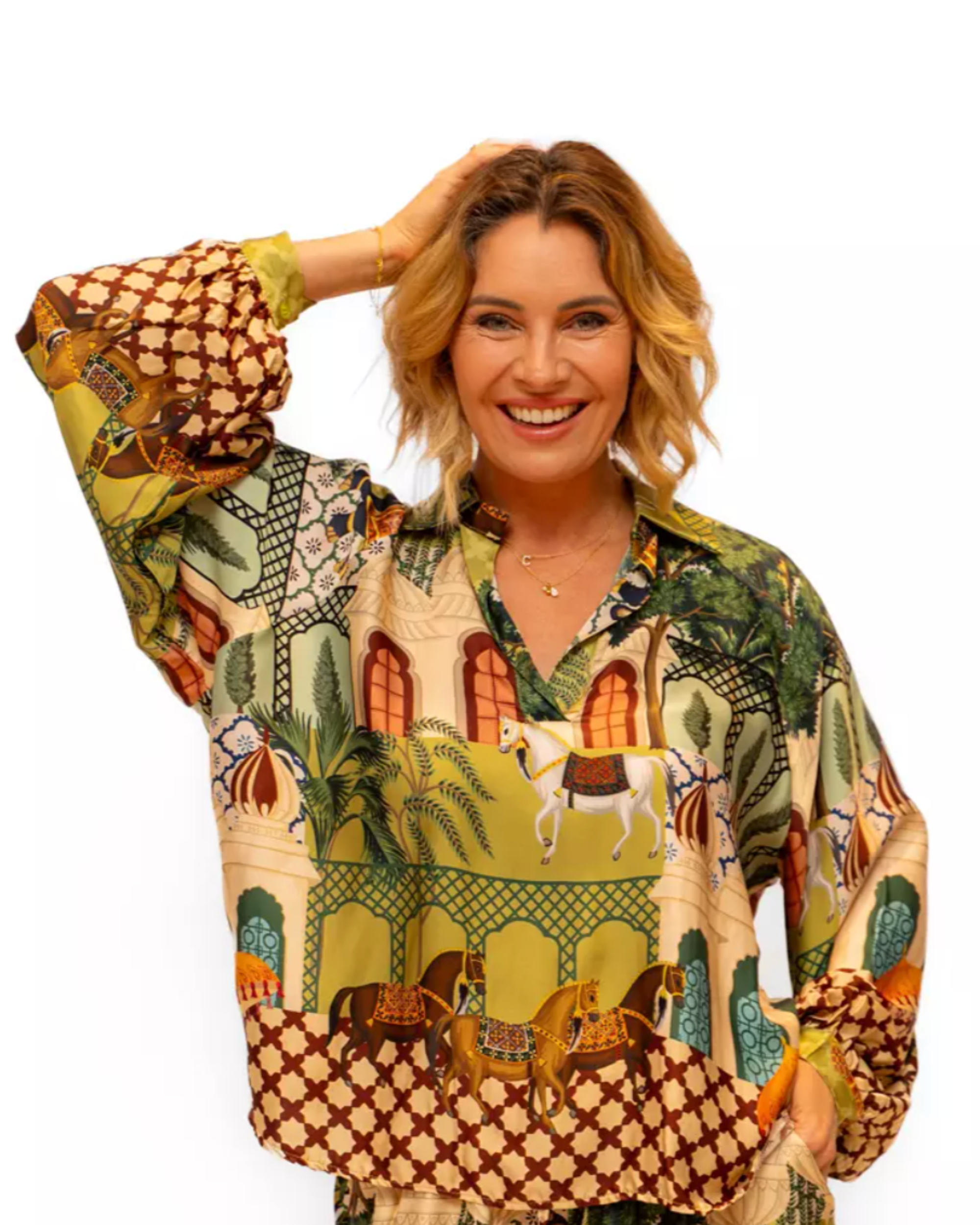 Woman wearing a colorful patterned blouse with a white background