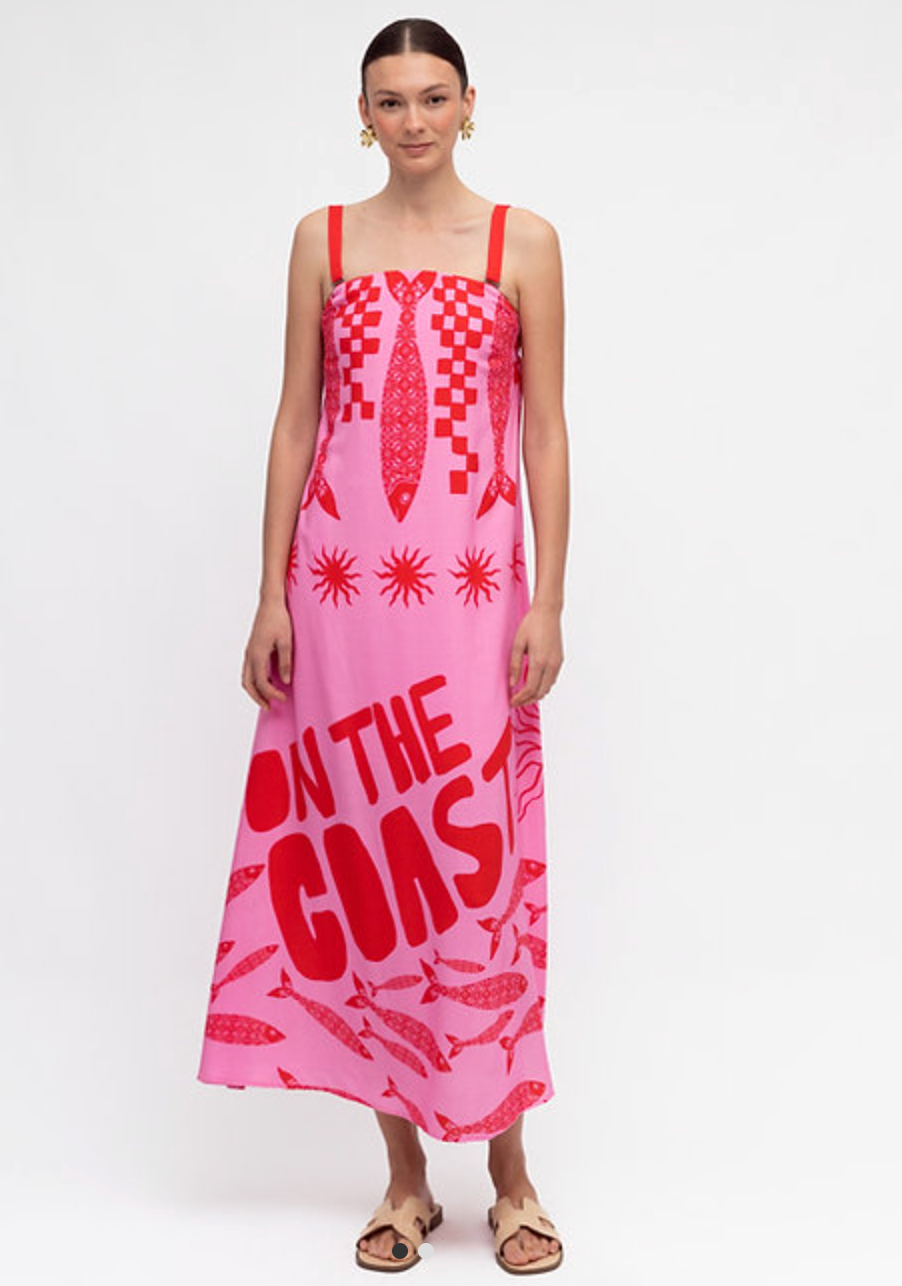 lady in red and pink sundress on the coast